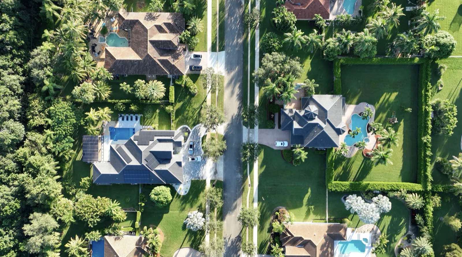 Aerial drone photography of a residential neighborhood with pools and palm trees in South Florida