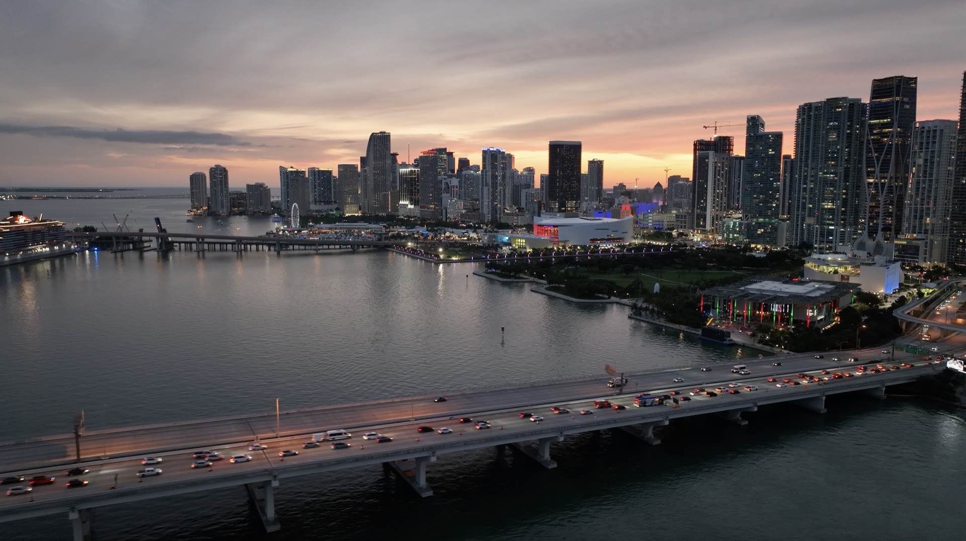 Sunset aerial drone view of Miami waterfront infrastructure and bridge development