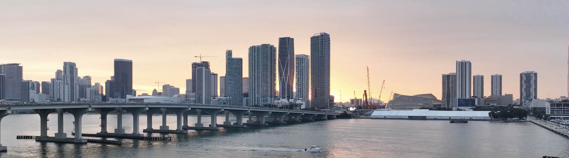 Panoramic drone view of the Miami skyline and Biscayne Bay at sunset